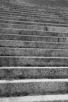 Focused near steps with many upward leading stairs in background