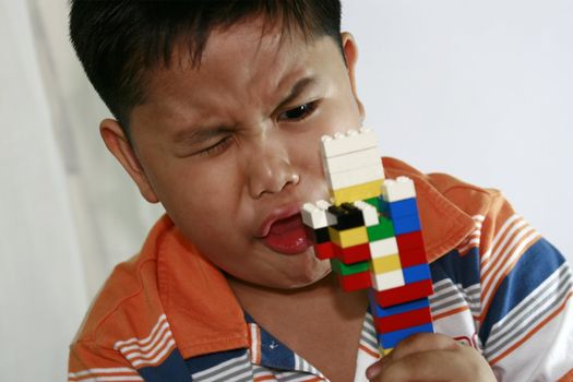 Child express joy over his buliding block toy