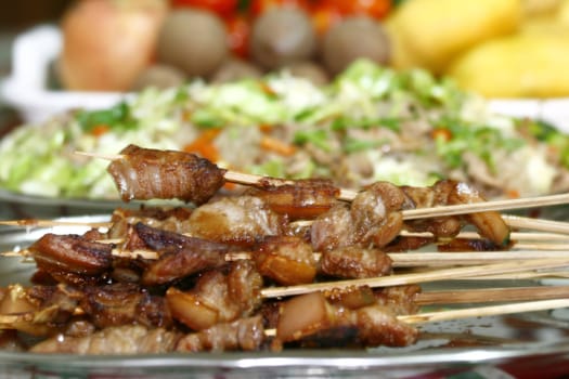 Focus on the barbecue dof with fruits and food on the table
