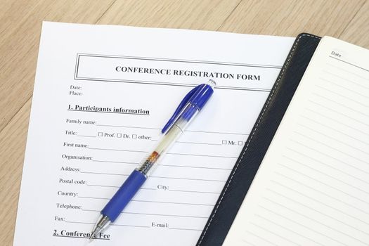 Registration form with notebook and pen - ready to fill-up form