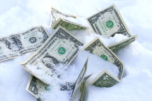 Dollar bills on the snow concept for frozen accounts