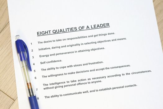 Eight qualities of a leader concept listed with a pen