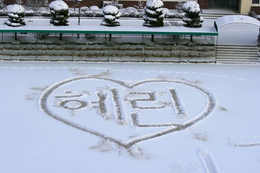 Writting on the snow with heart and love writtin in korean language