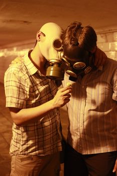 Two men in gas masks with flower in the tunnel