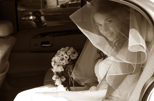 The beautiful bride in the automobile