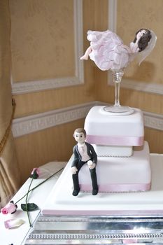 wedding cake with models of bride and groom
