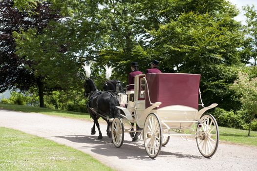 traditional horse drawn coach with driver and footman