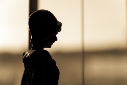 profile of old fashioned sepia woman in window