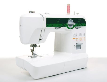 Electric sewing machine on a white background