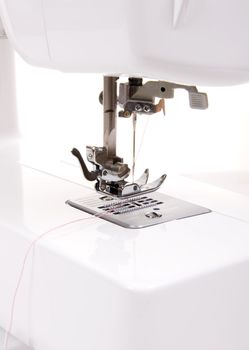 Electric sewing machine on a white background