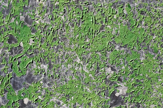 Close up view a green metal texture with peeled paint.