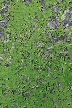 Close up view a green metal texture with peeled paint.