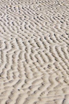 Sand ripple naturally formed by the low tide on the beach.