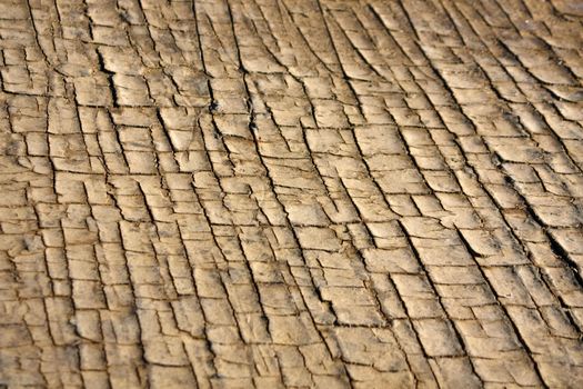 Close texture view of some dried out ground with many cracks.