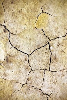 Close texture view of some dried out ground with many cracks.