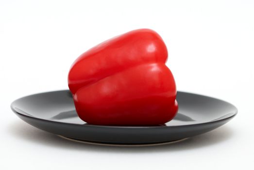 Red pepper on a black plate