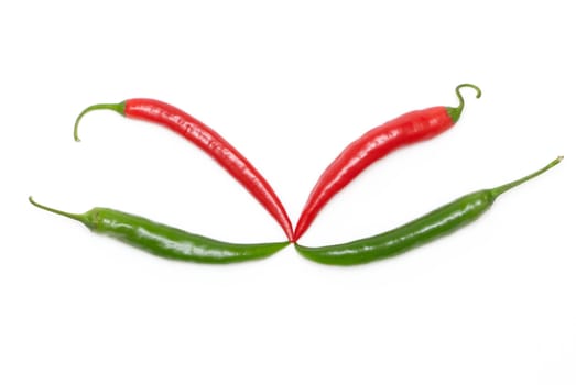 Red and green chili peppers on a white background