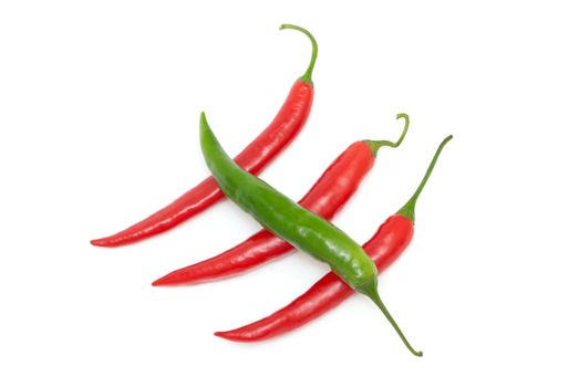 Color chili peppers diagonally on a white background