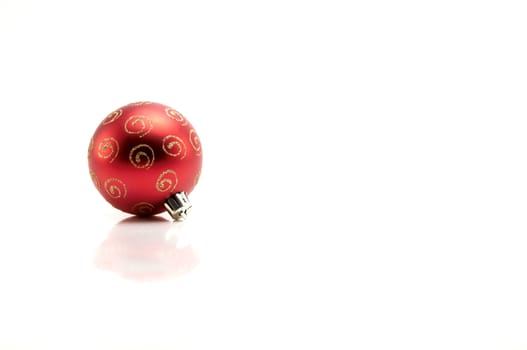 Red christmas bauble with gold glitter on white background