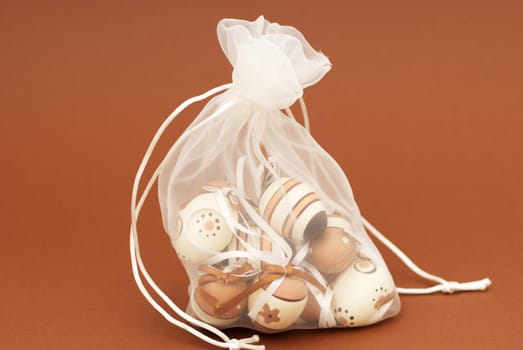 Easter eggs in a sack on a brown background
