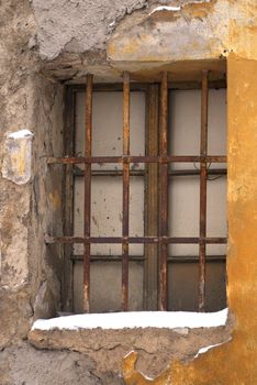 Window of an old house with a lattice and snow, Prague