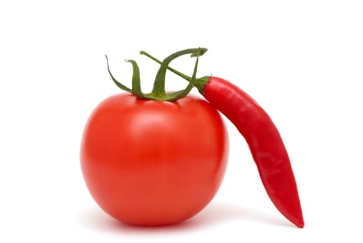 Tomato with red chili pepper on a white background