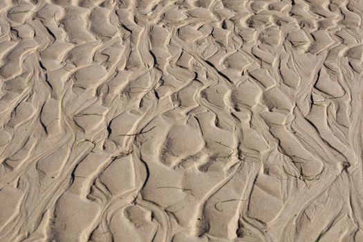 View of natural ripples made by the tide on the sand.