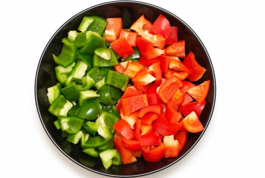 Red and green sweet pepper on a plate