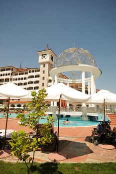 Hotel and swimmingpool. Clear blue sky.