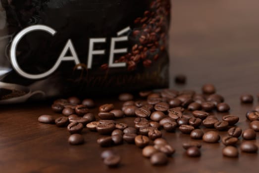 Coffee beans on a brown wooden table