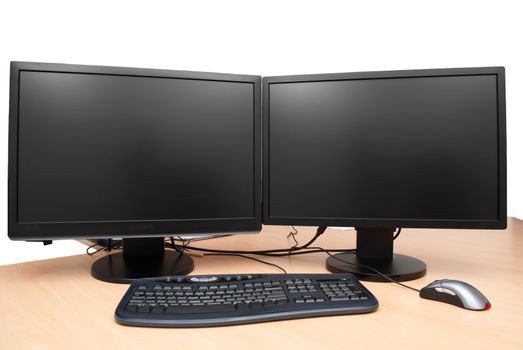 Two black monitors on the table