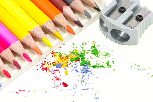 Pencils with a sharpener and shaving on a white background