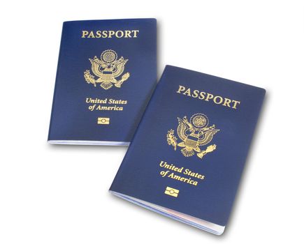 Two angled US, American passports isolated on white with shadow and clipping path