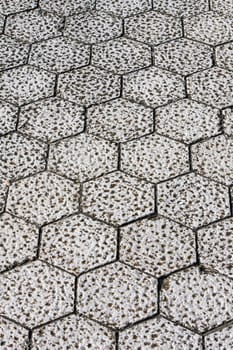 Close view of an hexagonal pattern on a stone floor.