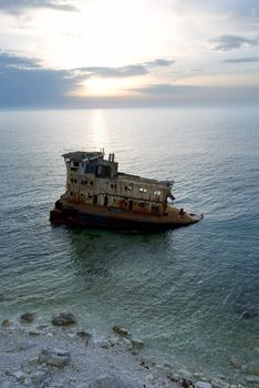 Rusty industrial ship near the coastline. Crimea
