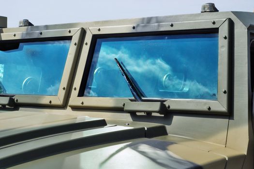closeup jeep glass with sky and clouds reflection