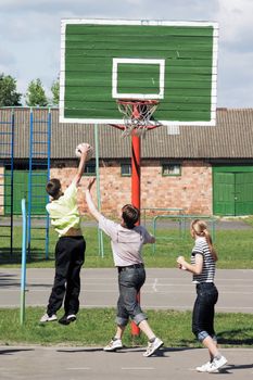 Game in basketball on an athletic field in town houses court yard