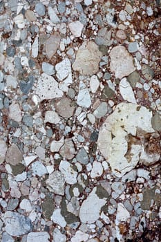 Close up view of a mixed marble textured wall.