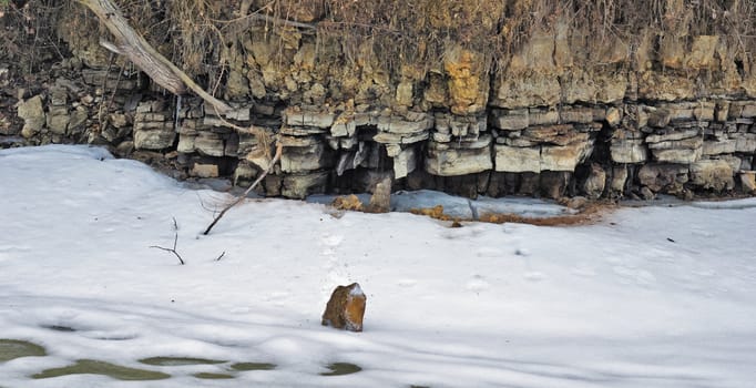 Layers of a dolomitic rock on the frozen lake coast