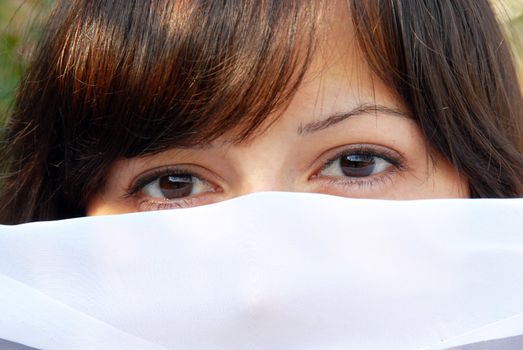 young brunette woman eyes and hair outdoor