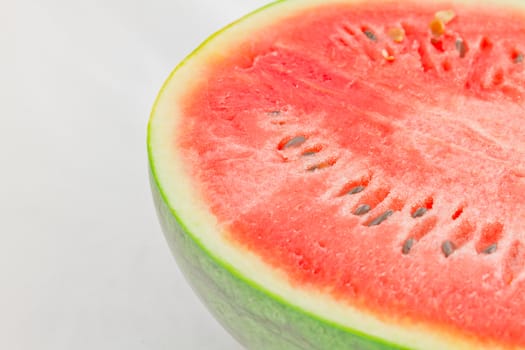 Half cut watermelon on white background.