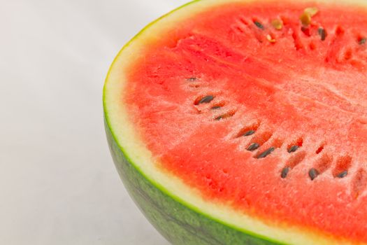 Half cut watermelon on white background.