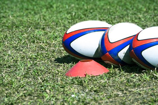 three rugby on the grass for texture