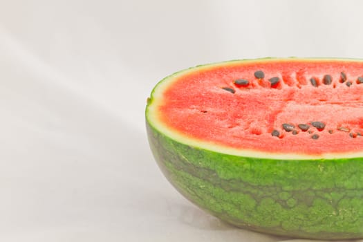 Half cut watermelon on white background.