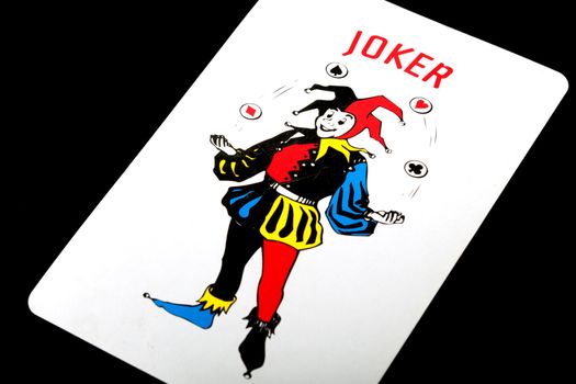 Playing card Joker on black background
