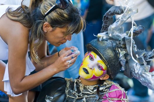 MONTEVIDEO, URUGUAY - JANUARY 28 : A carnaval participant has his face covered with makeup prior to participating in the annual national festival of Uruguay held in Montevideo Uruguay in January 28 2010 