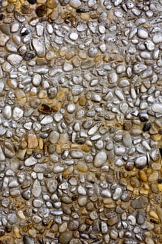 Close up view of a worn textured cement wall.