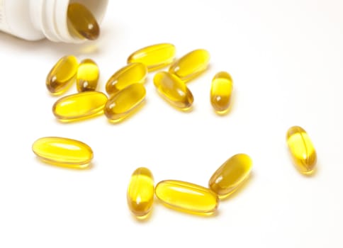 Yellow vitamin pills isolated on white background