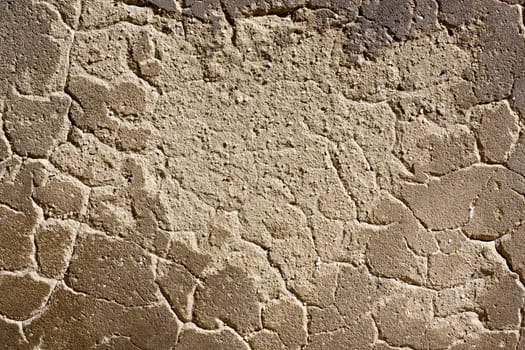 Close up view of a worn textured cement wall.