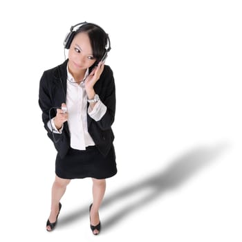 Young business woman listening music by Mp3 player and headphone isolated on white.